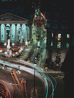 London Bank area in London at night with time-lapse so that car lights are lines